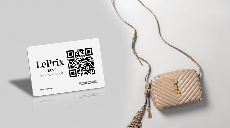 Luxury handbag, cards, and smartphone on a marble surface